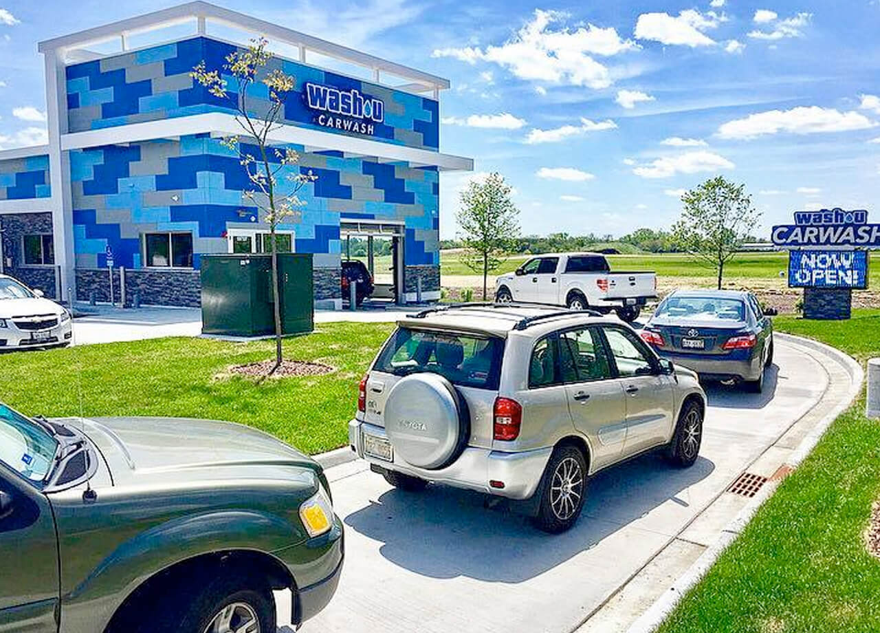 Row of cars entering a car wash building